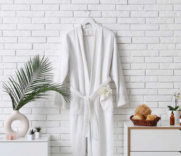 White bathrobe hanging on wall